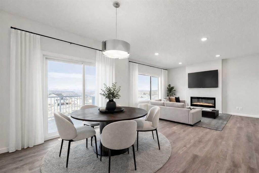 8 Heritage Link, Cochrane, AB - Indoor Photo Showing Dining Room With Fireplace