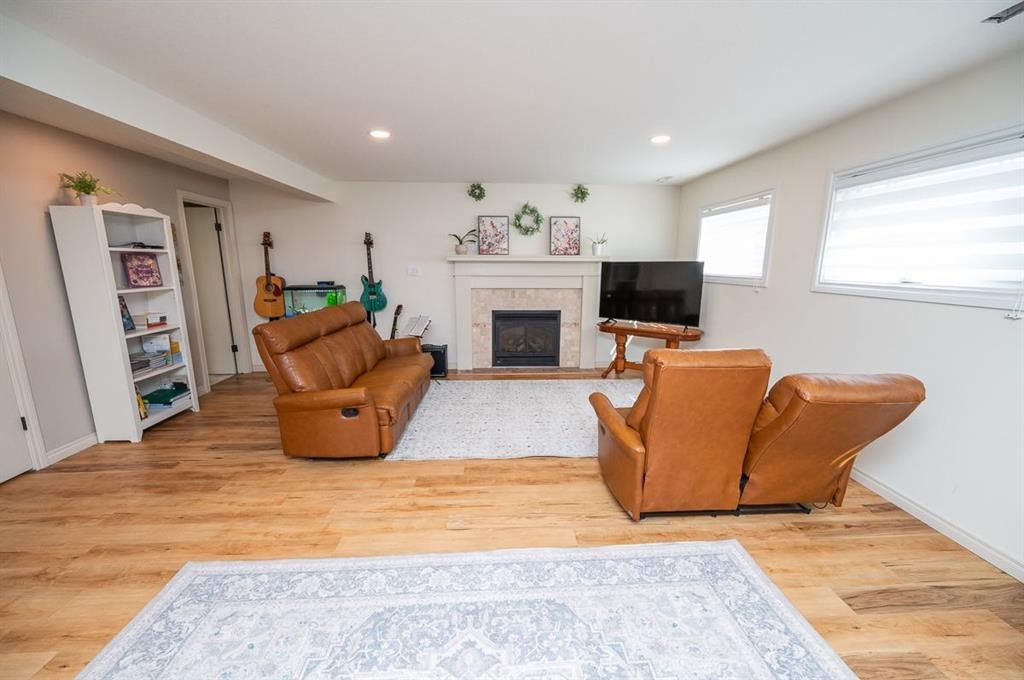 25 Gilbert Crescent, Red Deer, AB - Indoor Photo Showing Living Room With Fireplace