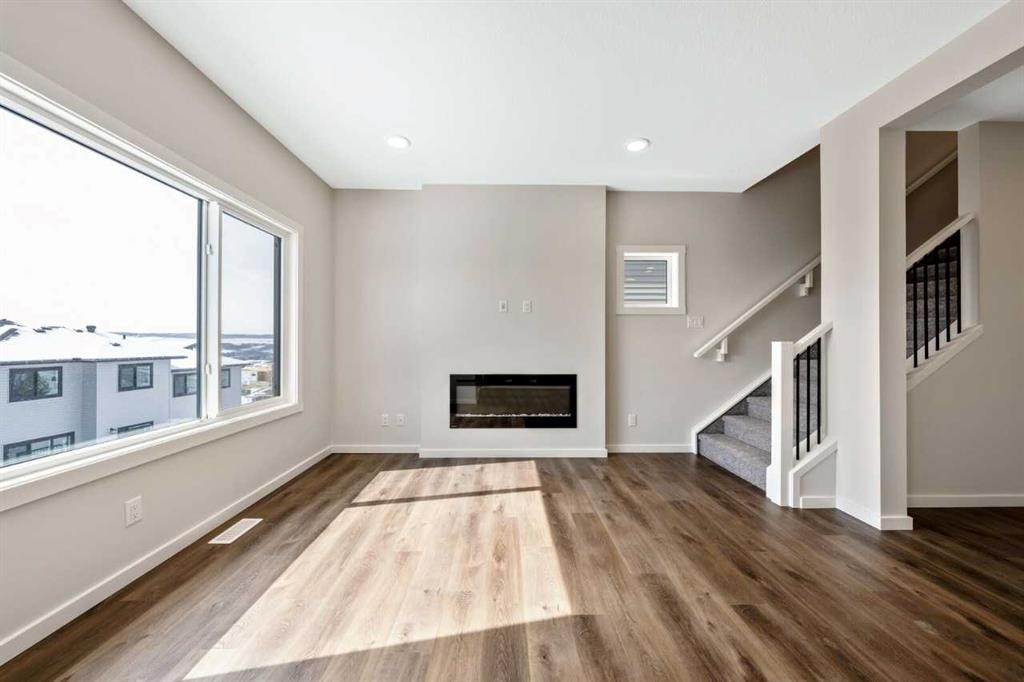 366 Heritage Boulevard, Cochrane, AB - Indoor Photo Showing Living Room With Fireplace