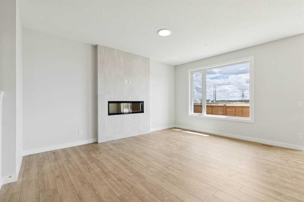 546 Hotchkiss Manor, Calgary, AB - Indoor Photo Showing Other Room With Fireplace