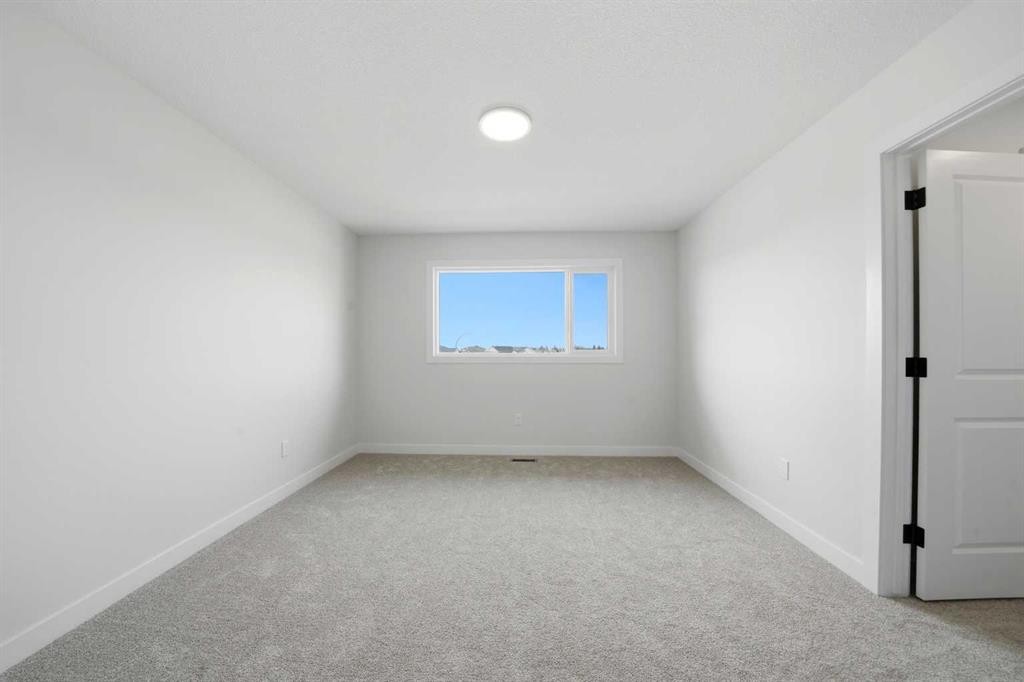 77 Pinnacle Close, Blackfalds, AB - Indoor Photo Showing Other Room