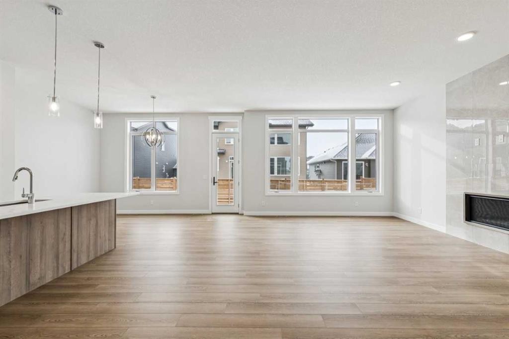 261 Dawson Wharf Crescent, Chestermere, AB - Indoor Photo Showing Other Room With Fireplace