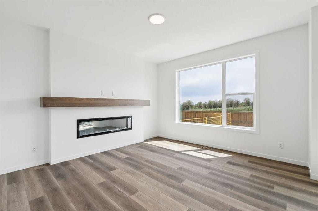 156 Southborough Common, Cochrane, AB - Indoor Photo Showing Living Room With Fireplace