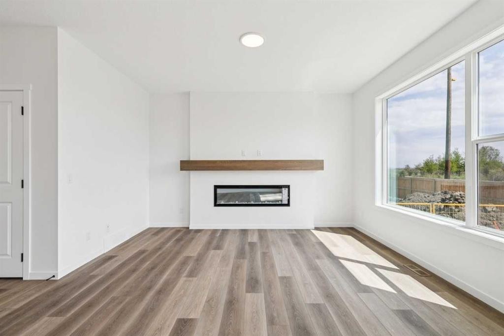 156 Southborough Common, Cochrane, AB - Indoor Photo Showing Living Room With Fireplace