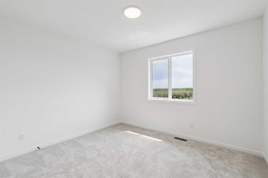 156 Southborough Common, Cochrane, AB - Indoor Photo Showing Other Room