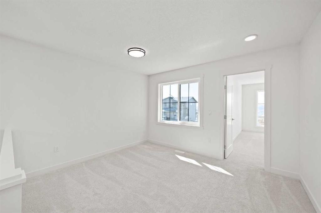 83 Heritage Manor, Cochrane, AB - Indoor Photo Showing Other Room