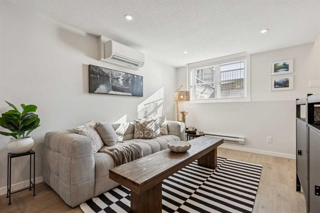 110-63 Belmont Passage Sw, Calgary, AB - Indoor Photo Showing Living Room