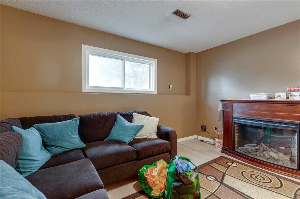 38 Heritage Drive, Lacombe, AB - Indoor Photo Showing Living Room With Fireplace