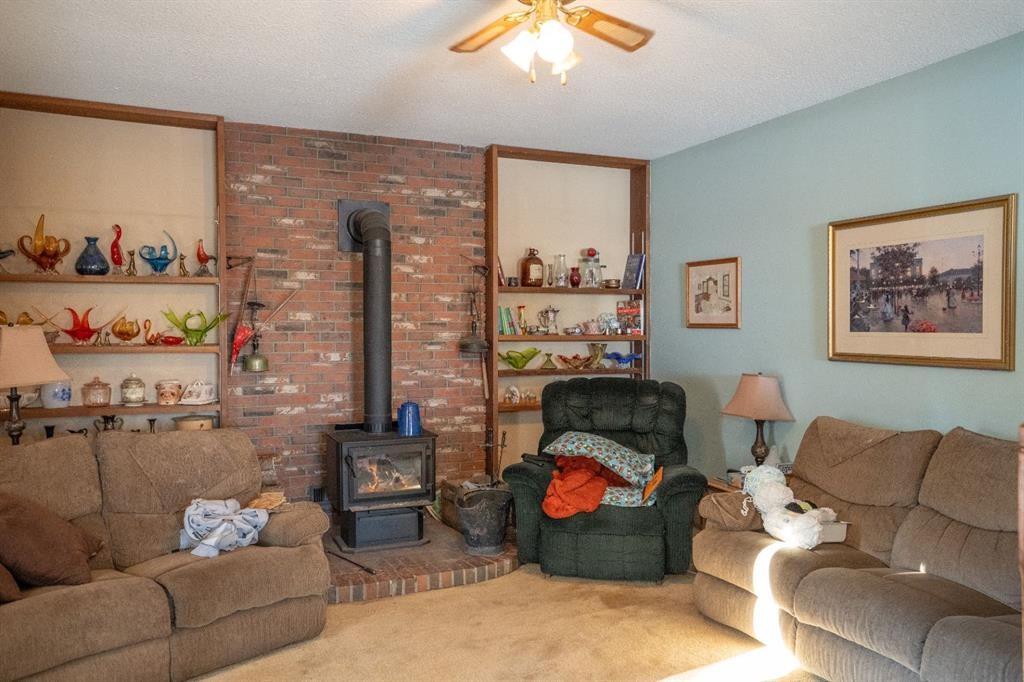 4908 47 Street, Clive, AB - Indoor Photo Showing Living Room With Fireplace