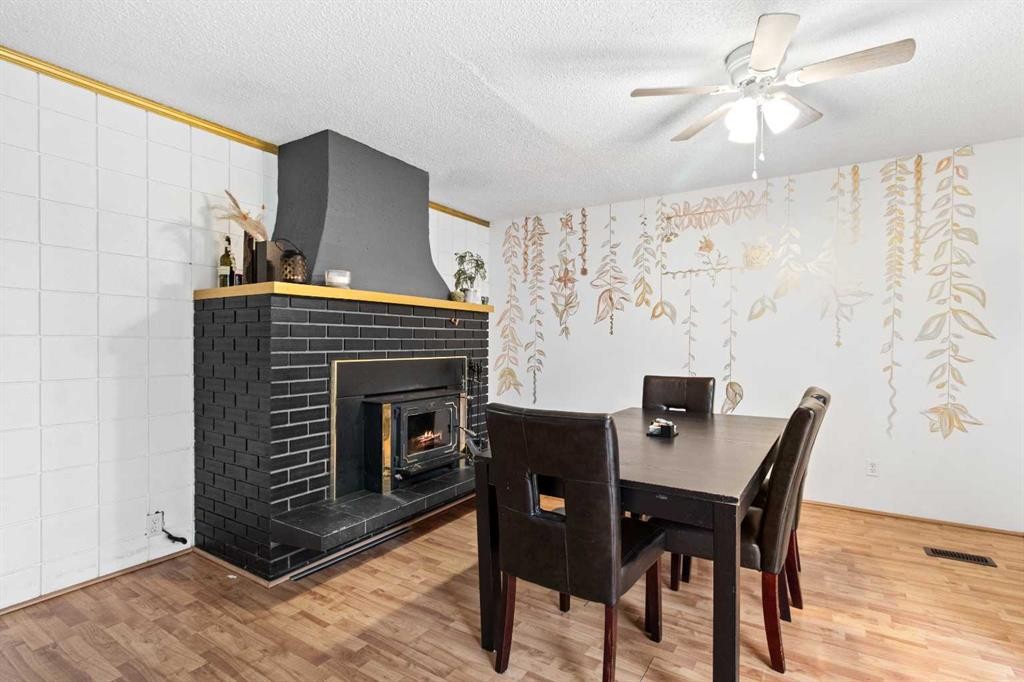 5224 50 Avenue, Sylvan Lake, AB - Indoor Photo Showing Dining Room With Fireplace