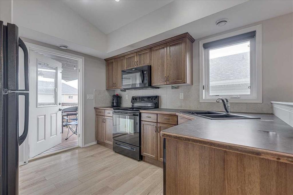 13 Rogers Road, Sylvan Lake, AB - Indoor Photo Showing Kitchen With Double Sink