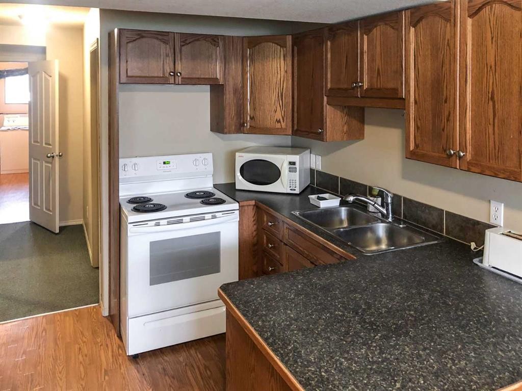 7019 Deer Street, Lacombe, AB - Indoor Photo Showing Kitchen With Double Sink