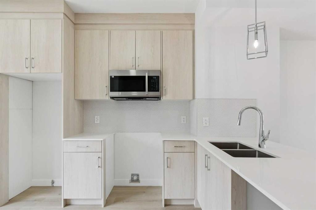 223-75 Cornerstone Row Ne, Calgary, AB - Indoor Photo Showing Kitchen With Double Sink