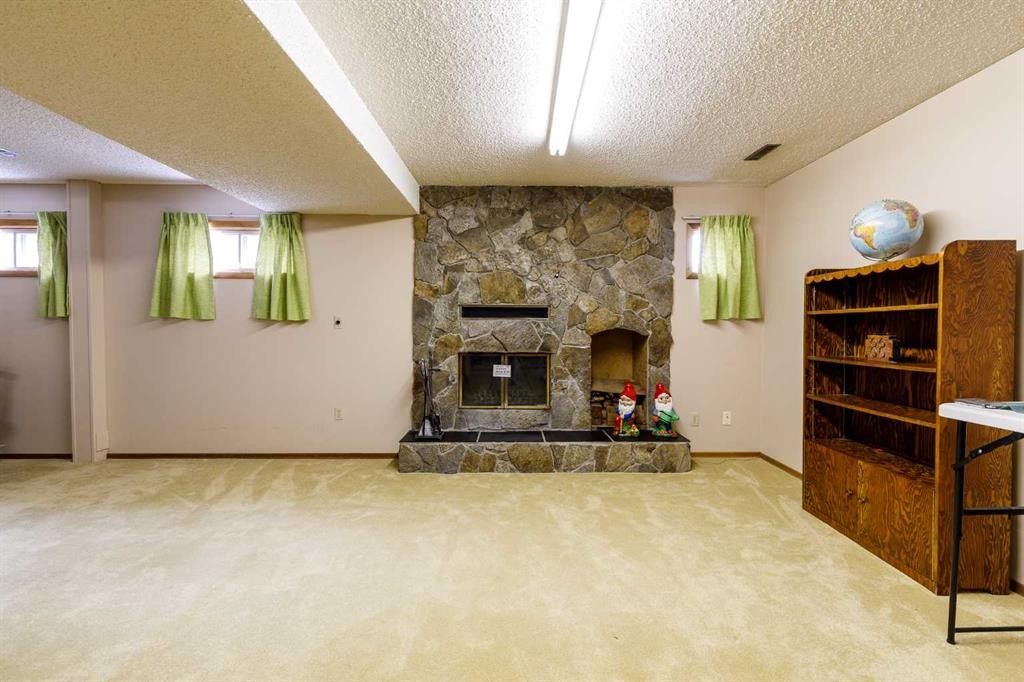 88 Mccullough Cresent, Red Deer, AB - Indoor With Fireplace