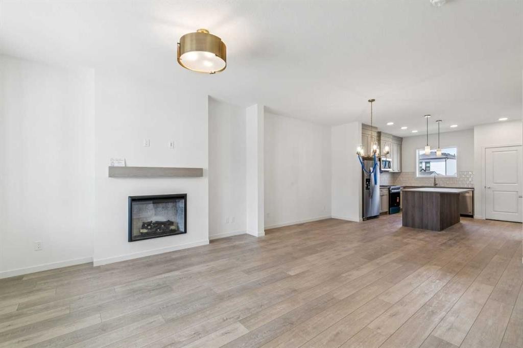 37 Bluerock Hill Sw, Calgary, AB - Indoor Photo Showing Other Room With Fireplace