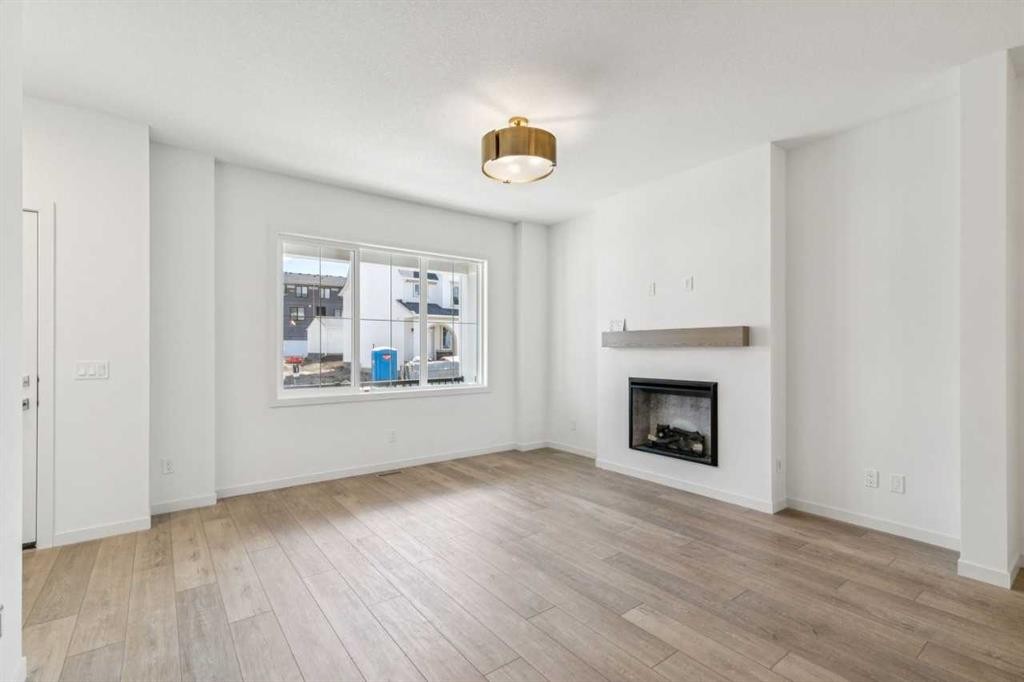 37 Bluerock Hill Sw, Calgary, AB - Indoor Photo Showing Living Room With Fireplace
