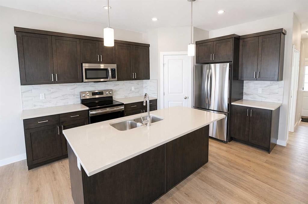 4438 Van Eaton Way, Clive, AB - Indoor Photo Showing Kitchen With Stainless Steel Kitchen With Double Sink With Upgraded Kitchen