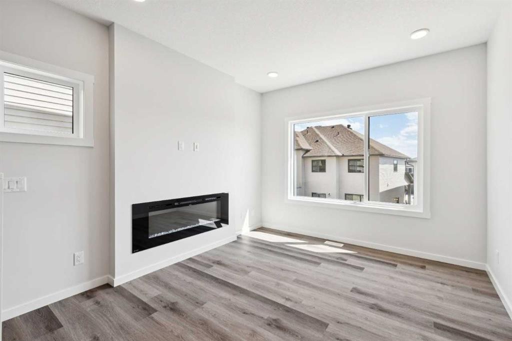 386 Heritage Boulevard, Cochrane, AB - Indoor Photo Showing Living Room With Fireplace