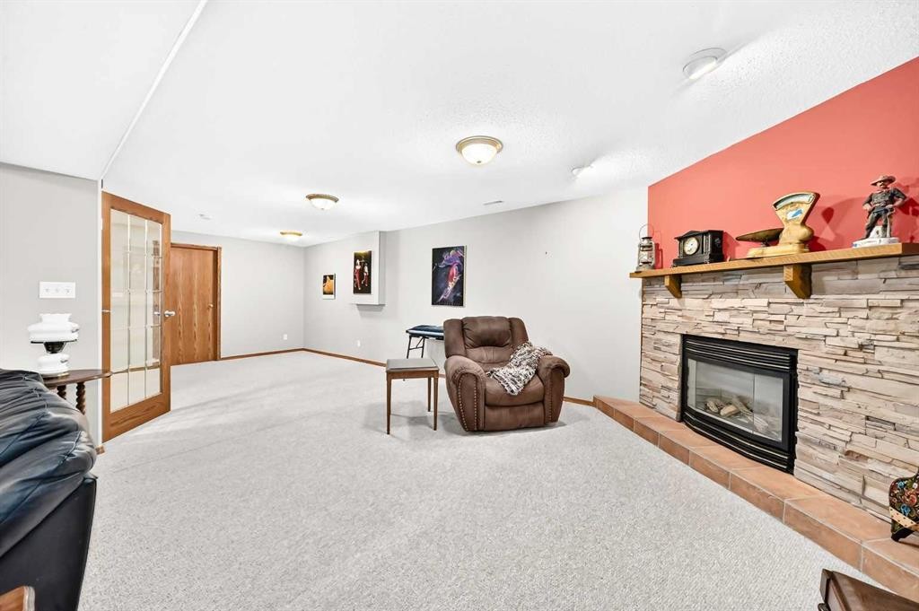 94 Hathaway Lane, Lacombe, AB - Indoor Photo Showing Other Room With Fireplace