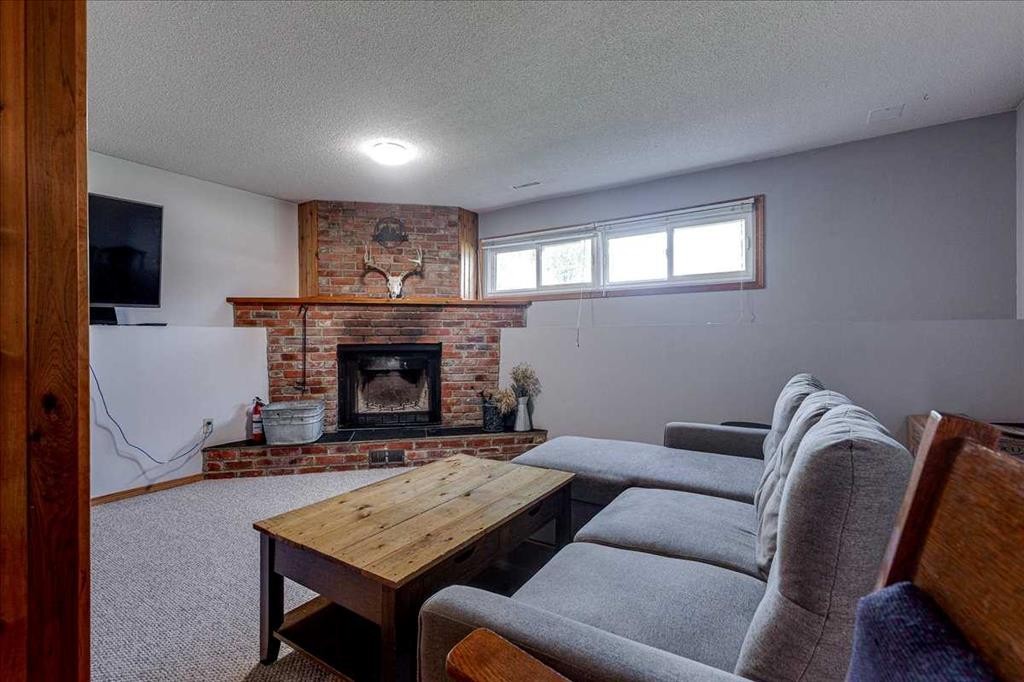 43 Oak Street, Red Deer, AB - Indoor Photo Showing Living Room With Fireplace