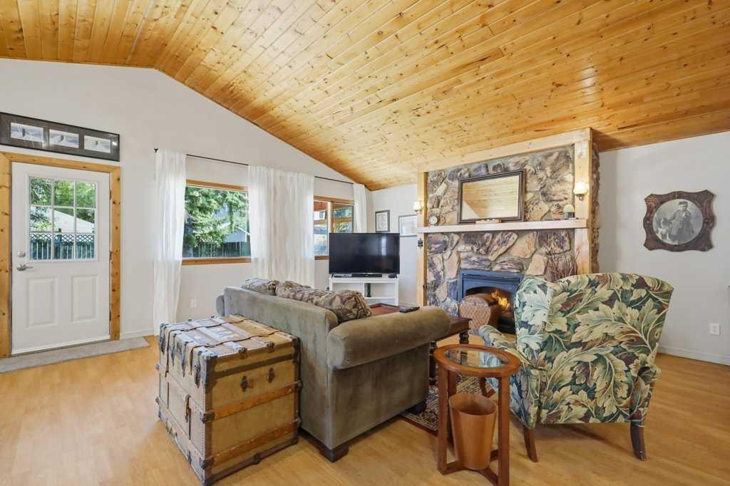 5127 50 A Avenue, Sylvan Lake, AB - Indoor Photo Showing Living Room With Fireplace
