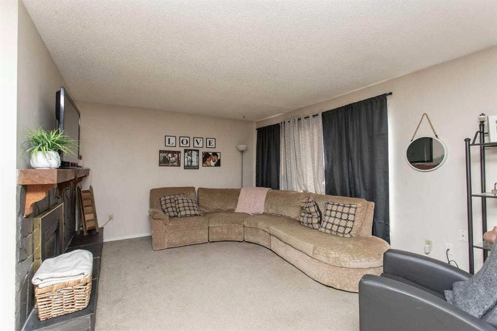 10 Valley Crescent, Lacombe, AB - Indoor Photo Showing Living Room With Fireplace