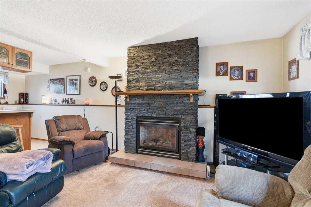 5616 45Th Street, Innisfail, AB - Indoor Photo Showing Living Room With Fireplace