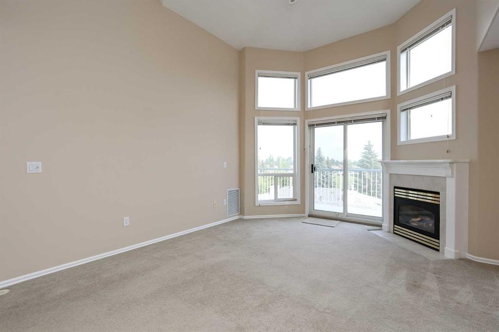 409-6118 53 Avenue, Red Deer, AB - Indoor With Fireplace