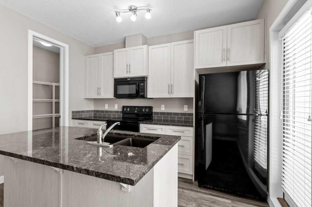 702-125 Caribou Crescent, Red Deer, AB - Indoor Photo Showing Kitchen With Double Sink