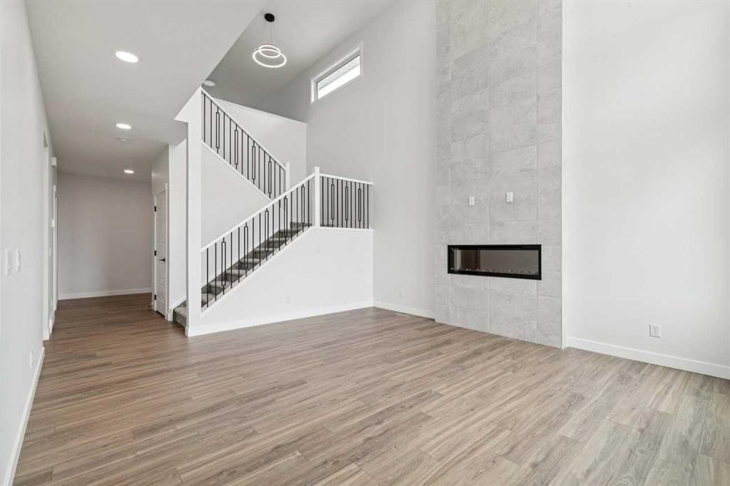 412 Bridgeport Glen, Chestermere, AB - Indoor Photo Showing Other Room With Fireplace