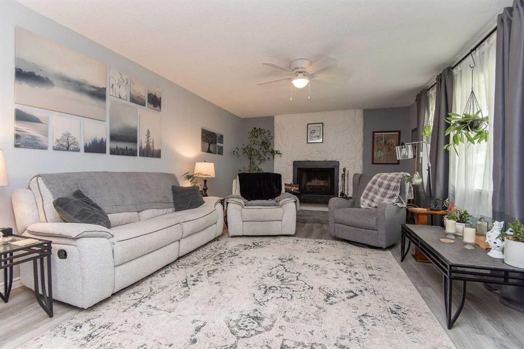 4606 51 Avenue, Bentley, AB - Indoor Photo Showing Living Room With Fireplace