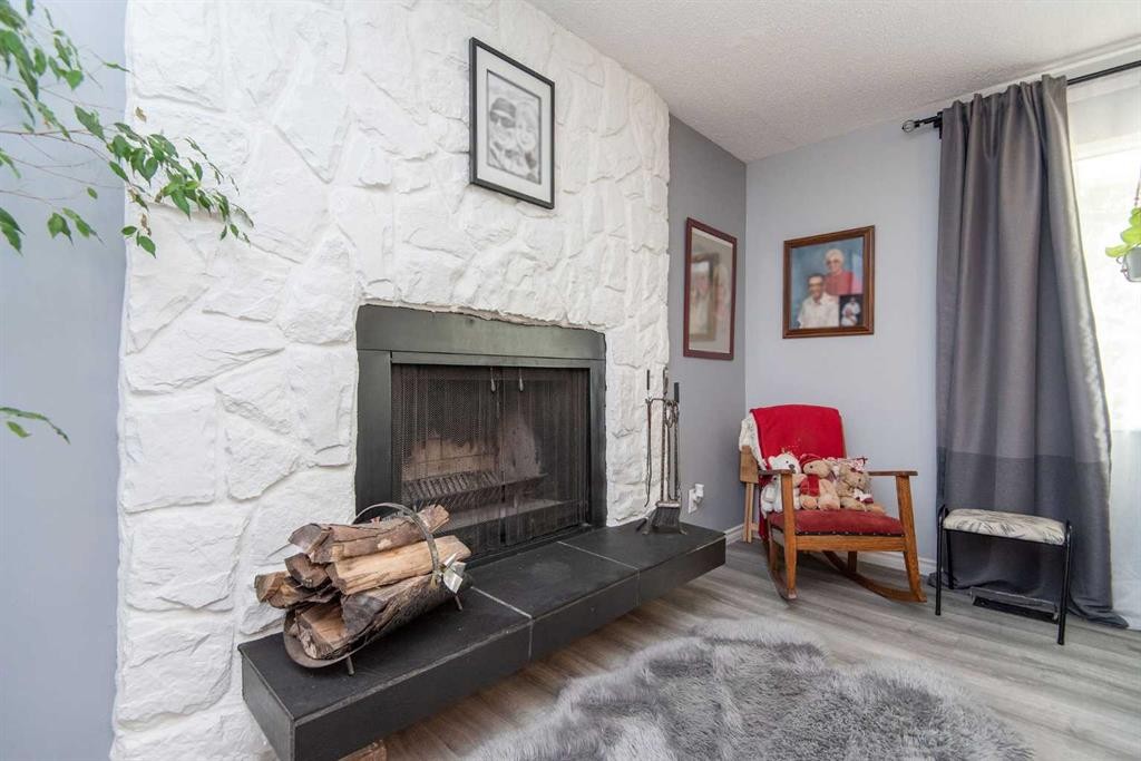 4606 51 Avenue, Bentley, AB - Indoor Photo Showing Living Room With Fireplace