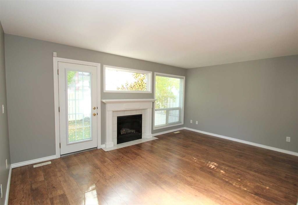 52-73 Addington Drive, Red Deer, AB - Indoor Photo Showing Living Room With Fireplace
