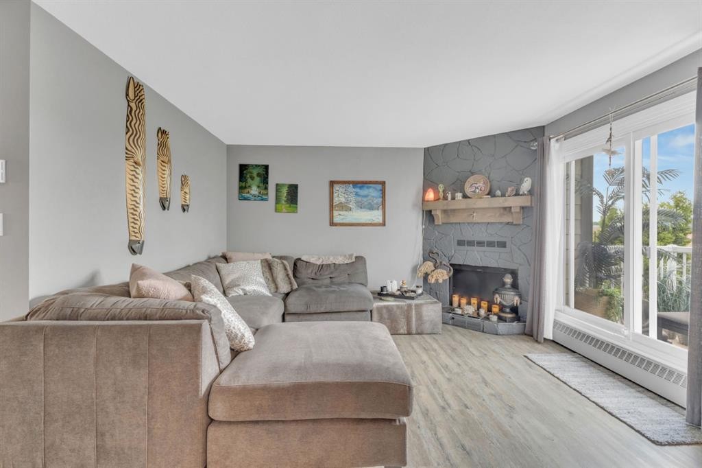 301-71 Cosgrove Crescent, Red Deer, AB - Indoor Photo Showing Living Room With Fireplace