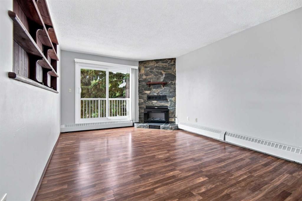 305-71 Cosgrove Crescent, Red Deer, AB - Indoor Photo Showing Living Room With Fireplace
