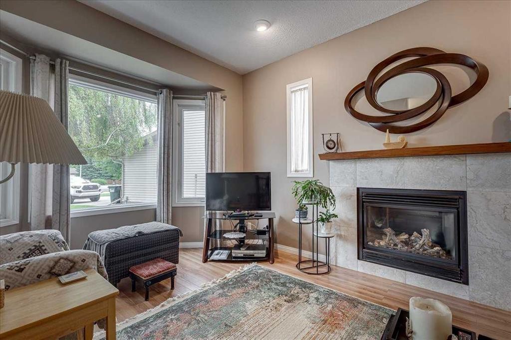 11 West Heights Drive, Didsbury, AB - Indoor Photo Showing Living Room With Fireplace