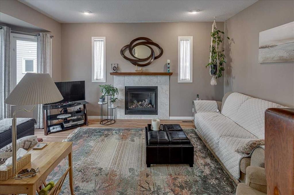 11 West Heights Drive, Didsbury, AB - Indoor Photo Showing Living Room With Fireplace