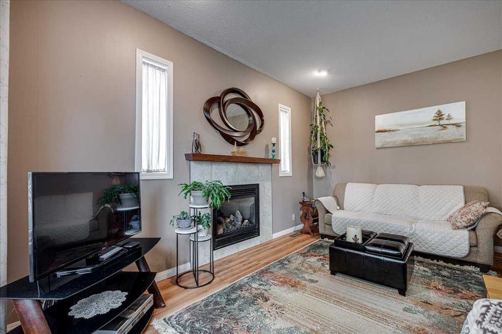 11 West Heights Drive, Didsbury, AB - Indoor Photo Showing Living Room With Fireplace
