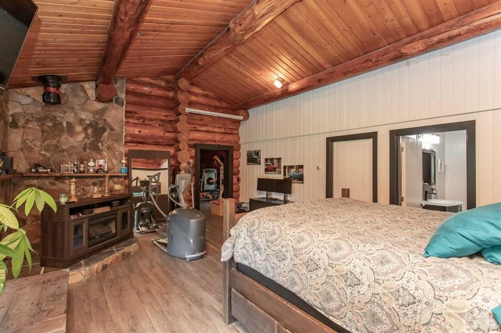 34470 Range Road 20, Rural Red Deer County, AB - Indoor Photo Showing Bedroom With Fireplace