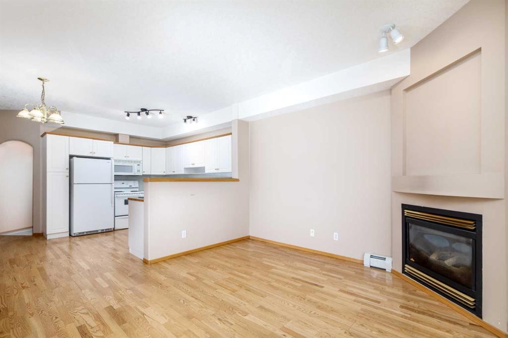 105-4512 52 Avenue, Red Deer, AB - Indoor Photo Showing Other Room With Fireplace