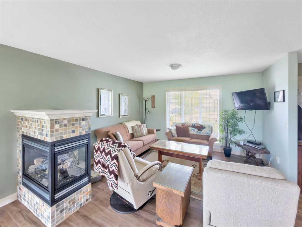 128 12 Ave Ne, Sundre, AB - Indoor Photo Showing Living Room With Fireplace