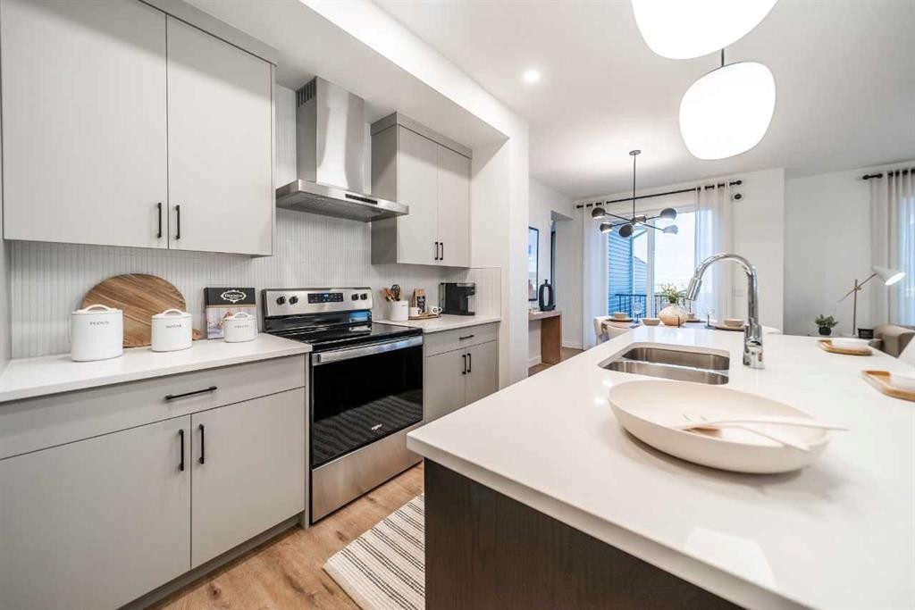 52 Southborough Common, Cochrane, AB - Indoor Photo Showing Kitchen With Double Sink With Upgraded Kitchen