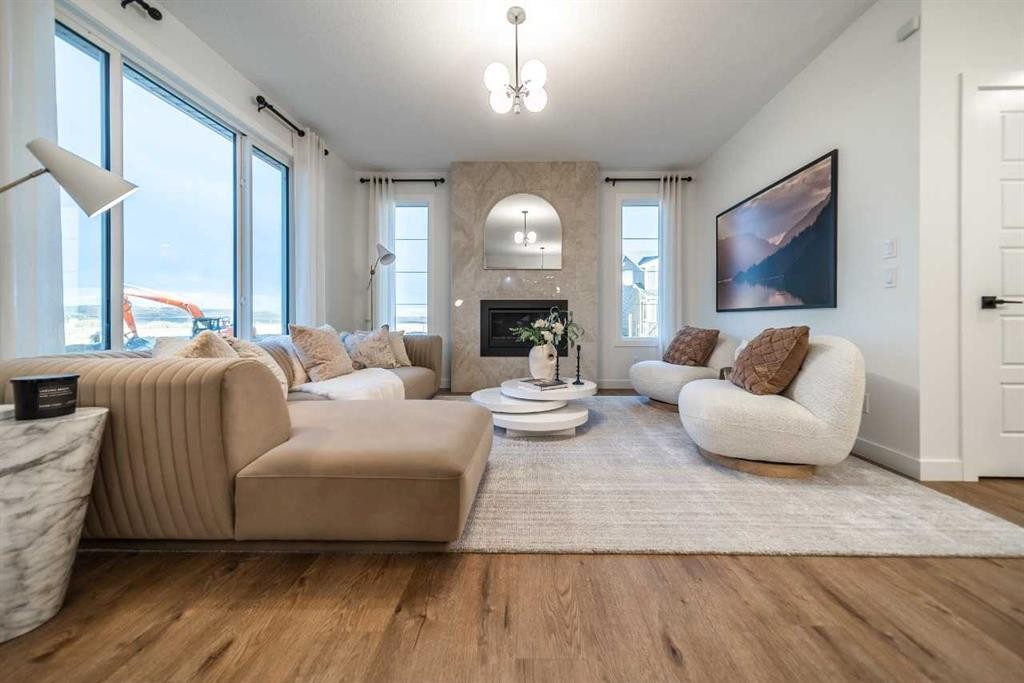 52 Southborough Common, Cochrane, AB - Indoor Photo Showing Living Room With Fireplace