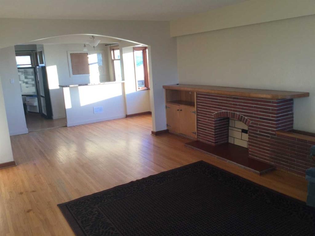 42082 Range Road 274, Hill Spring, AB - Indoor Photo Showing Other Room With Fireplace