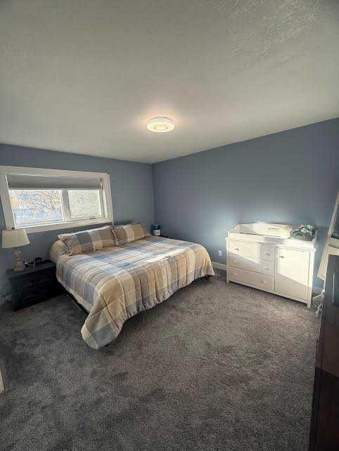 486N 100E, Raymond, AB - Indoor Photo Showing Bedroom