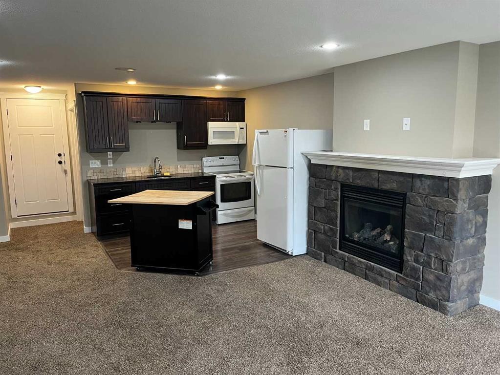 295 Sixmile Ridge South, Lethbridge, AB - Indoor Photo Showing Kitchen With Fireplace