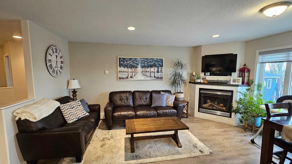 448 Willow Place, Picture Butte, AB - Indoor Photo Showing Living Room With Fireplace
