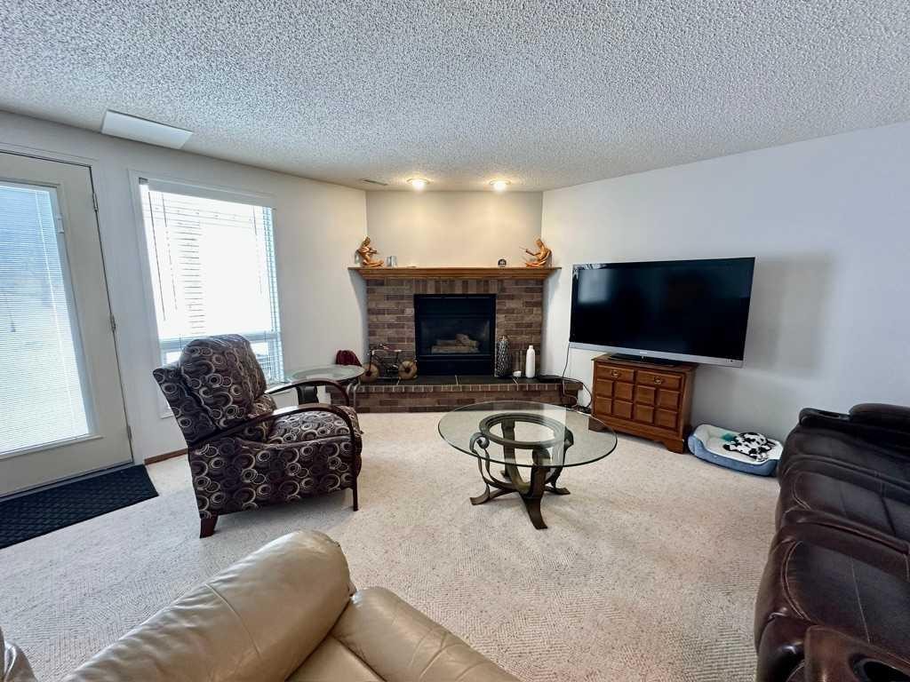 211 Canyon Boulevard West, Lethbridge, AB - Indoor Photo Showing Living Room With Fireplace