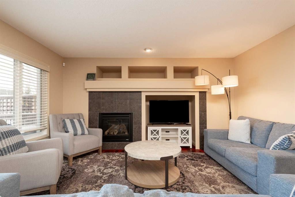 443 Everbrook Way Sw, Calgary, AB - Indoor Photo Showing Living Room With Fireplace