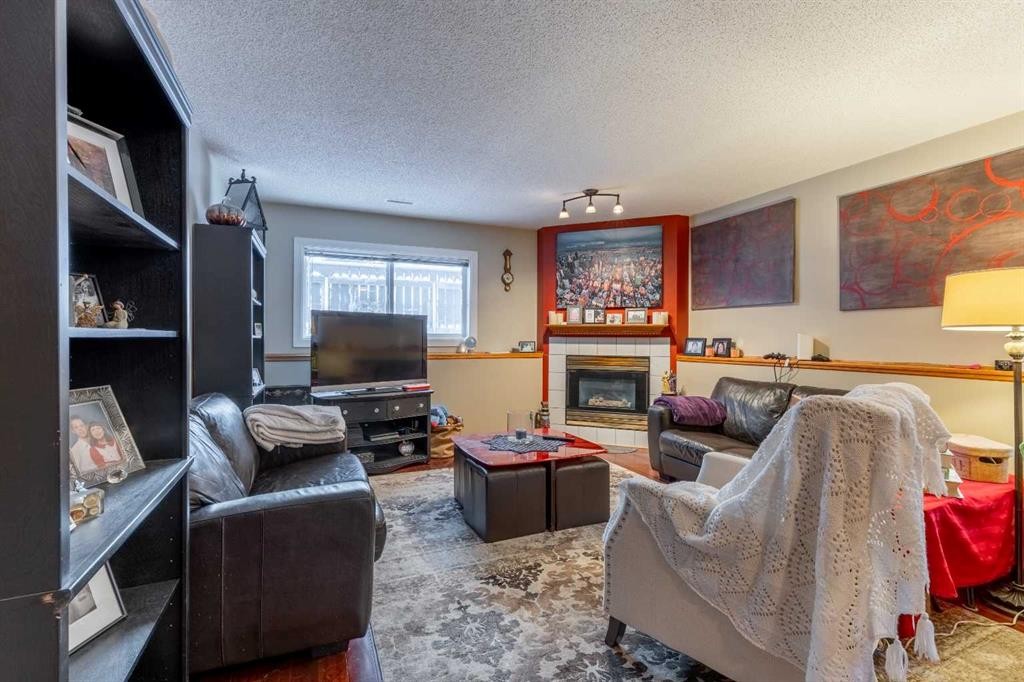 327 Heritage Crescent West, Lethbridge, AB - Indoor Photo Showing Living Room With Fireplace
